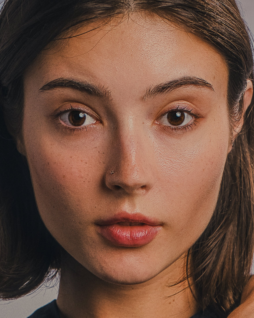 Close-up portrait of Alla against a softly lit neutral background.